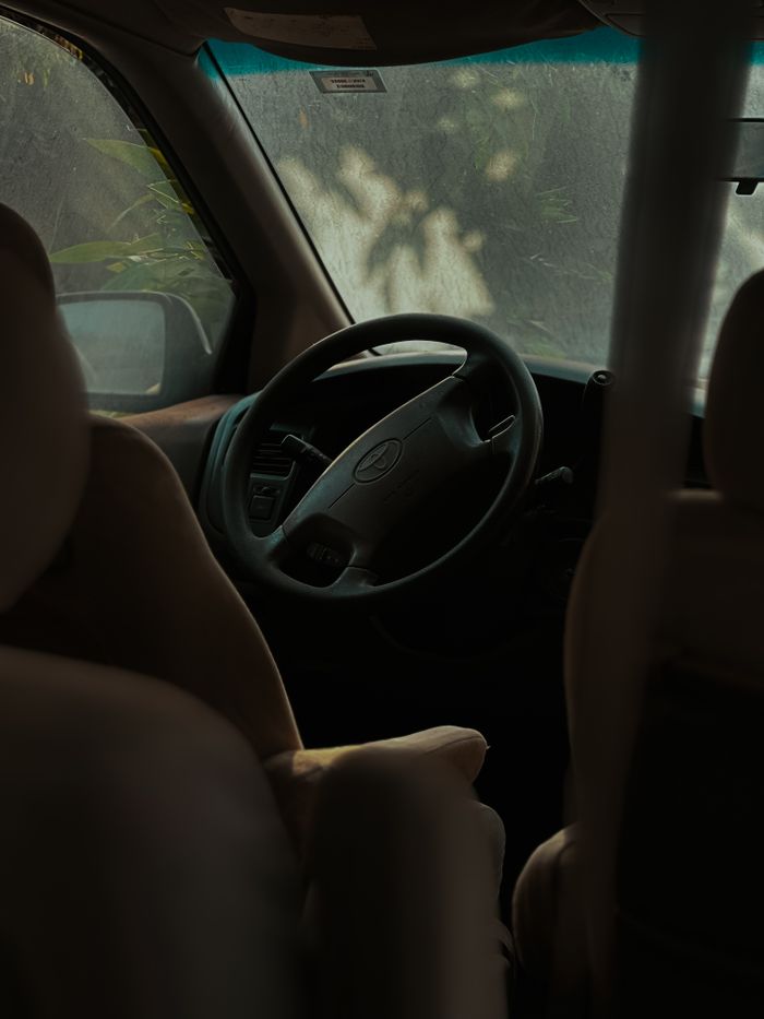 gallery-6 Moody car interior view featuring a steering wheel and seats.